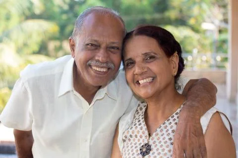 Closeup portrait, retired couple in white shirt and dress holding each other  Stock Photos