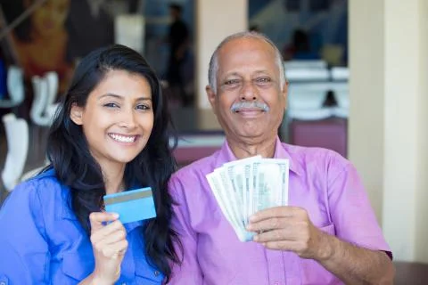 Closeup portrait rich elderly gentleman in pink shirt and lady in blue top ho Stock Photos