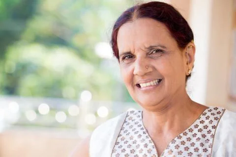 Closeup portrait, senior woman smiling on isolated outdoors outside backgroun Stock Photos