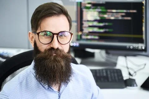 Closeup portrait of a serious computer programmer developer working in IT office Stock Photos