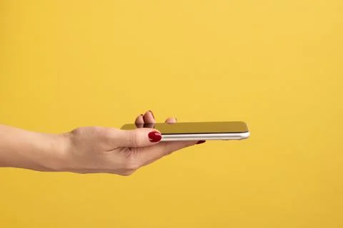 Closeup portrait of smartphone flat lying on open woman palm, female giving Foto stock