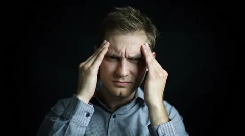 Closeup portrait of stressed man with headache, isolated on black background Stock Footage 40028124