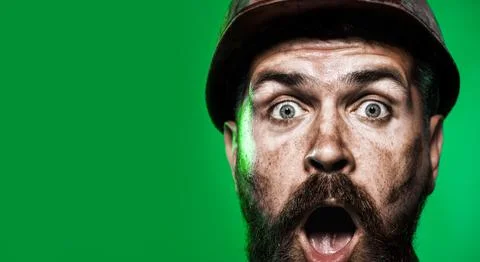 Closeup portrait surprised construction worker in hard hat. Amazed bearded in Stock Photos