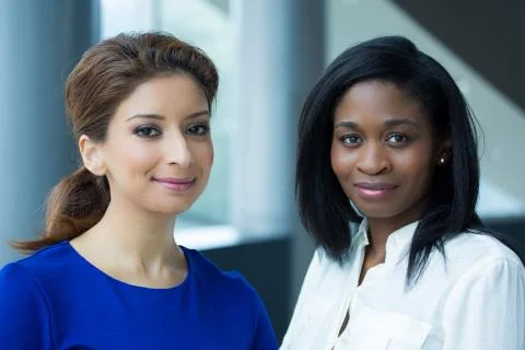 Closeup portrait, two office workers standing together united in their workpl Foto stock