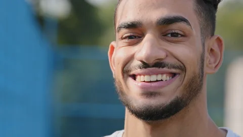 Closeup portrait of young ambitious Middle Eastern Indian guy with wide white Stock Footage 162045885