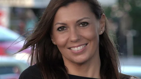 Closeup portrait of a young and attractive woman smiling in the city Stock Footage 67957166