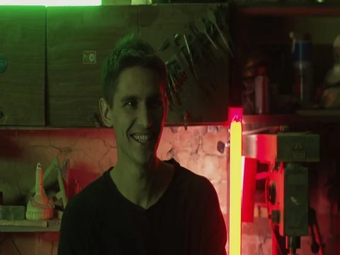 Closeup Portrait of young crafter under green and red neon light Stock Footage 73663395