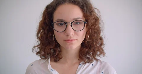 Closeup portrait of young cute long haired curly caucasian female smiling Stock Footage 109813676