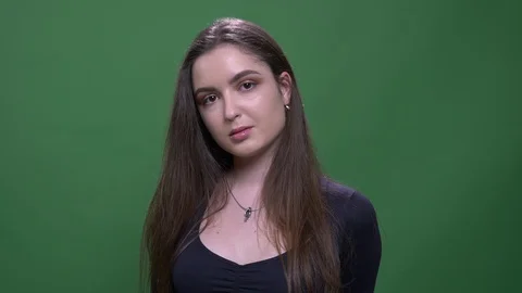 Closeup portrait of young cute pretty brunette female looking at camera with Stock Footage 108660992