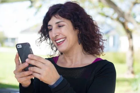 Closeup portrait, young happy business woman in black shirt standing, checkin Stock Photos