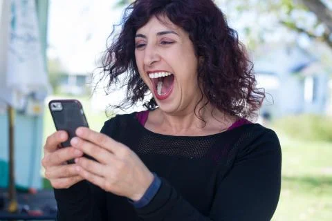 Closeup portrait, young happy business woman in black shirt standing, checkin Stock-Fotos