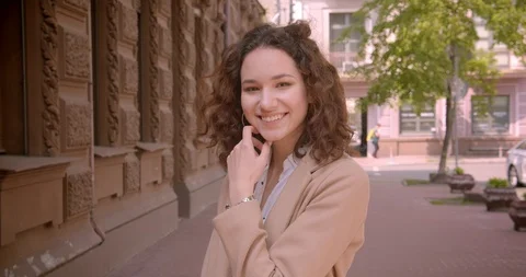 Closeup portrait of young long haired curly caucasian female student smiling Video stock 109835198