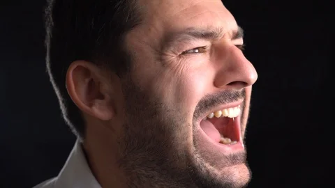 Closeup portrait of a young man screaming out loud Video stock 101650855