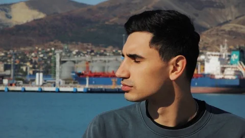 Closeup portrait of young man thinking in sunny day, in slow motion Stock Footage 118217568