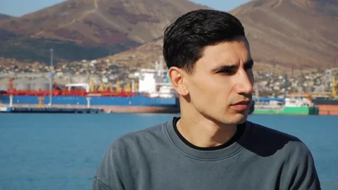 Closeup portrait of young man thinking in sunny day, in slow motion Stock Footage 118217614