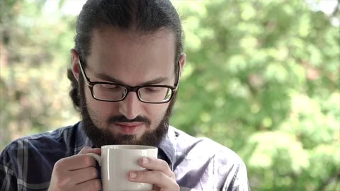 Closeup portrait of young office man enjoy smelling of a cup of fresh coffee Stock Footage 76771595
