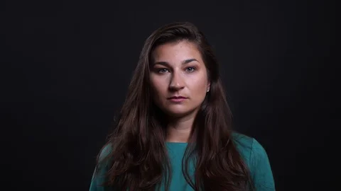 Closeup portrait of young pretty brunette female looking at camera with Video stock 108894271