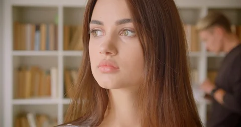 Closeup portrait of young pretty caucasian female student looking at camera Stock Footage 113407053