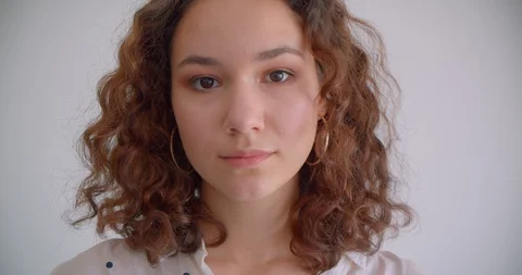 Closeup portrait of young pretty long haired curly caucasian female looking at Video stock 109803891