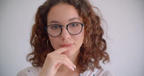 Closeup portrait of young pretty long haired curly caucasian female in glasses Stock Footage 109808875