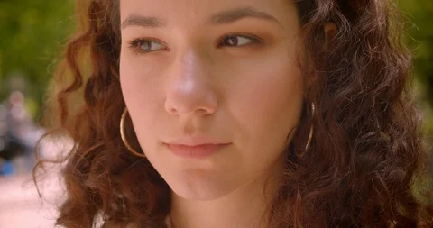Closeup portrait of young pretty long haired curly caucasian female looking at Video stock 109857322