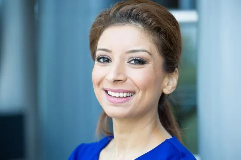 Closeup portrait, young professional, beautiful confident woman in blue dress Stock Photos