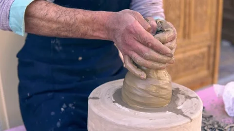 Closeup of potter making clay vase on mechanical pottery wheel Stockbeeldmateriaal 155047917