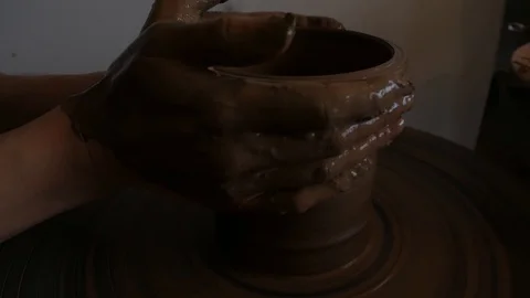 Closeup of potter's hand working behind a potter's wheel. Stock Footage 98514663