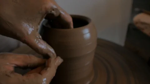 Closeup of potter's hand working behind a potter's wheel. Stock Footage 98514714