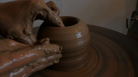Closeup of potter's hand working behind a potter's wheel. Stock Footage 98514747