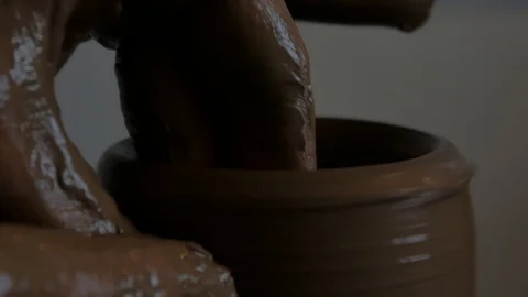 Closeup of potter's hand working behind a potter's wheel. Stock Footage 98514835