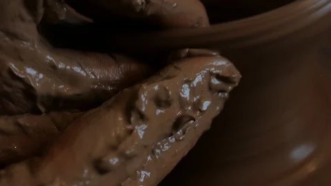 Closeup of potter's hand working behind a potter's wheel. Stock Footage 98514845