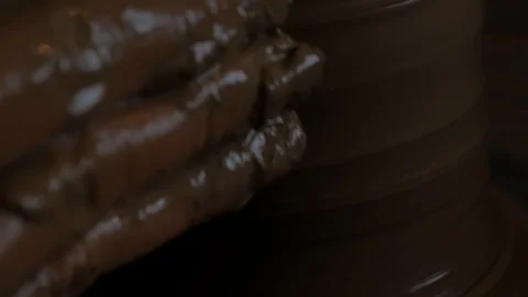Closeup of potter's hand working behind a potter's wheel. Stock Footage 98514850