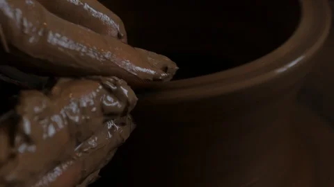Closeup of potter's hand working behind a potter's wheel. Stock Footage 98514889