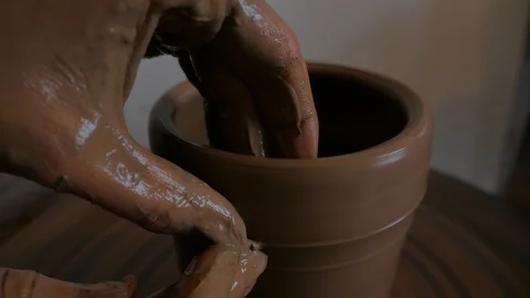 Closeup of potter's hand working behind a potter's wheel. Stock Footage 98514892
