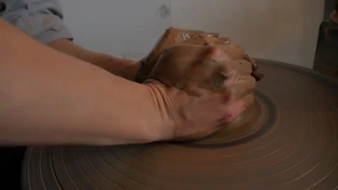 Closeup of potter's hand working behind a potter's wheel. Stock Footage 98584942