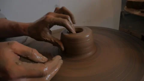 Closeup of potter's hand working behind a potter's wheel. Stock Footage 98585013