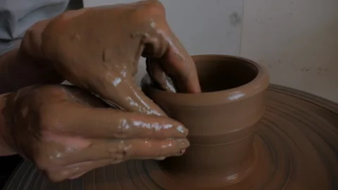 Closeup of potter's hand working behind a potter's wheel. Stock Footage 98585026