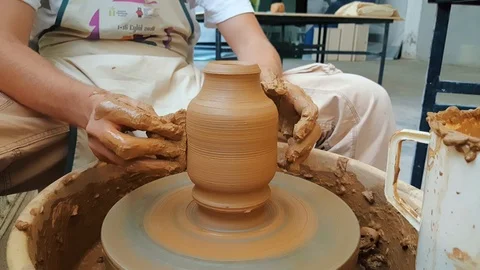 Closeup of a pottery artist hands making clay pot at the 12th International Stock Footage 104032323