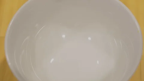 Closeup pouring Corn Flakes to white bowl. Slow Motion Stock Footage 109418778