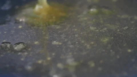 Closeup of pouring ghee in a cooking pan  Stock Footage 299779254