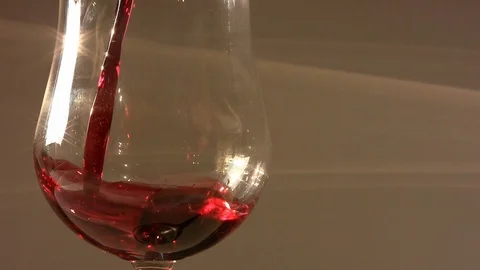Closeup of Pouring red wine into an elegant glass Stock Footage 104956159