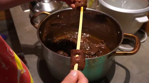 Closeup preparing and putting anticucho meats on a wooden stick to cook it on th Stock Footage 199514139