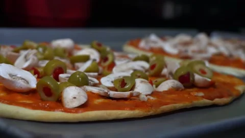 Closeup preparing homemade pizza in the kitchen with mushrooms and green olives Video stock 164581047
