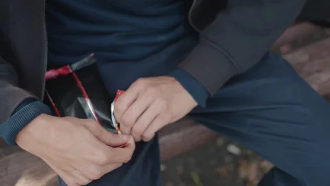 Closeup of preparing shiny pack, Tense gestures during street rehearsal activity Stock Footage 331071765