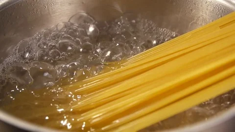 Closeup of preparing spaghetti in boiling water. Preparing pasta in slow motion Stock Footage 72249537