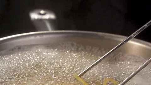 Closeup of preparing spaghetti in boiling water. Preparing pasta in slow motion Stockbeeldmateriaal 72249612