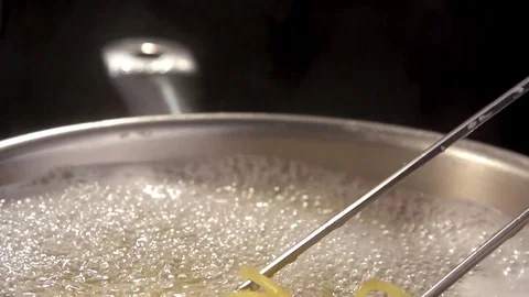 Closeup of preparing spaghetti in boiling water. Preparing pasta Stock Footage 72404897