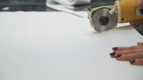 Closeup of the process of cutting fabrics on an industrial electric machine in a Stock Footage 125524080