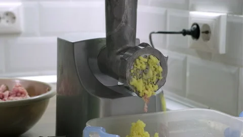 Closeup process of grinding potato in the kitchen through electric grinder Video stock 165575815